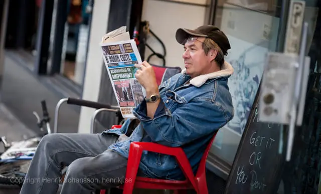 Man is reading news paper (picture taken with Canon EOS 5D Mark II and Canon EF 135mm F2 L USM )