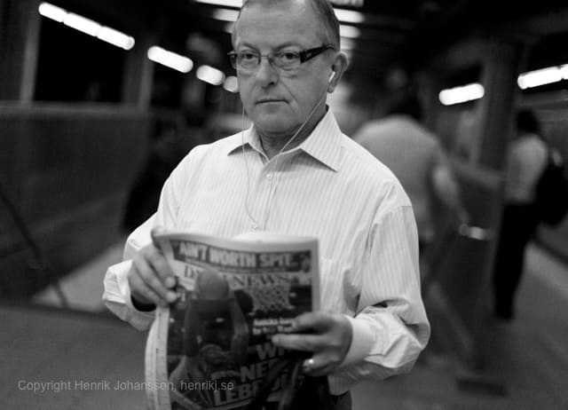 Man reading his news paper in subway (picture taken with Canon EOS 5D Mark II and Canon EF 50mm F1.4 USM )