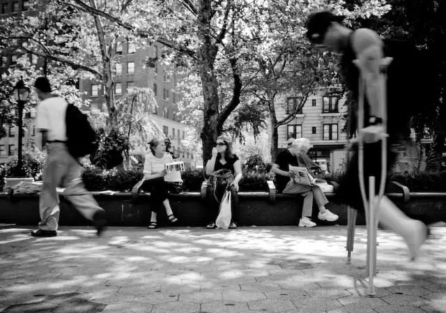 Man with crutches walking inside a park (picture taken with Canon EOS 40D and Canon EF 16-35mm F2.8 L USM)