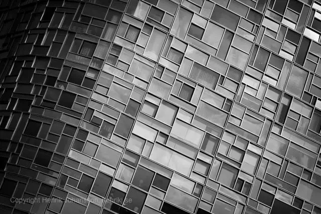 The side of a building is covered in glass (picture taken with Canon EOS 5D Mark II and Canon EF 135mm f/2 L USM )