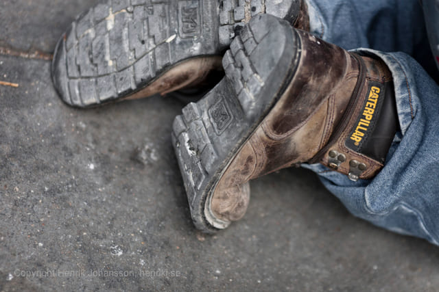 Worker in jeans and Caterpillar boots (picture taken with Canon EOS 5D Mark II and Canon EF 135mm f/2 L USM )