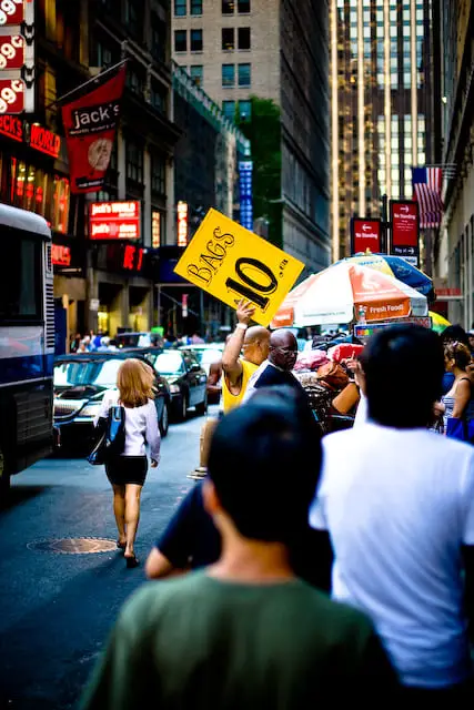 Sign in yellow that says 'Bags 10 USD' (picture taken with Canon EOS 1D Mark III and Canon EF 50mm F1.4 USM )