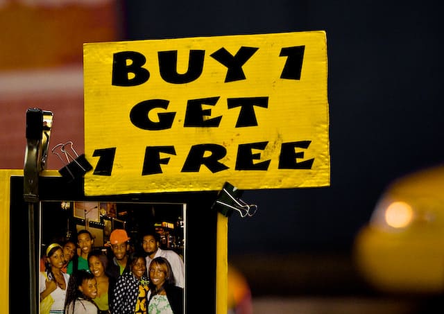 Yellow sign that says Buy 1 Get 1 Free (picture taken with Canon EOS 1D Mark III and Canon EF 135mm f/2 L USM )