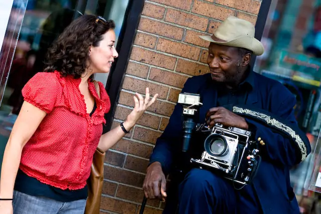 Woman stops buy an older camera guy (picture taken with Canon EOS 1D Mark III and Canon EF 135mm f/2 L USM )