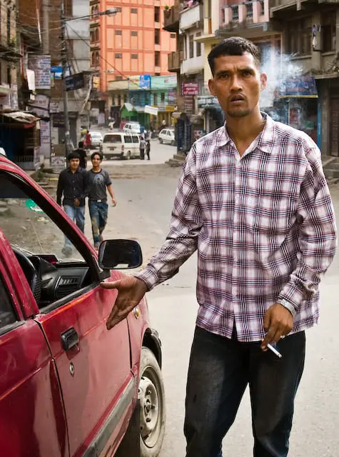 Guy that smokes is entering a red car (picture taken with Canon EOS 1D Mark III and Canon EF 16-35mm F2.8 L USM)