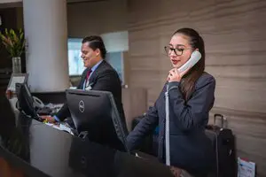 Hotel Receptionist is answering the phone